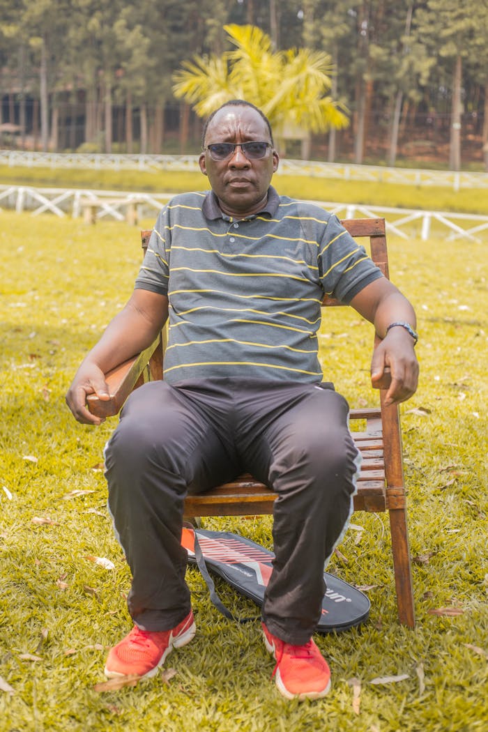 man-sitting-outdoors-on-wooden-chair-in-park-35165475